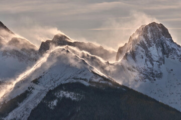 Strong wind in mountains. Glowing snow on mountain peaks. Canadian Rockies. Kooteney. British Columbia.  Canada 