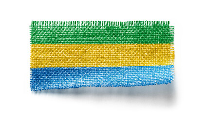 Gabon flag on a piece of cloth on a white background