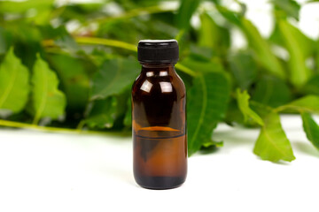 neem oil in bottle and neem leaf isolate on white background.