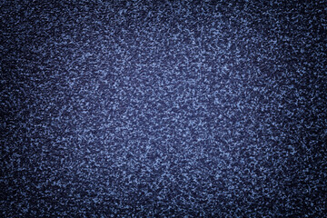 Grainy navy blue background of tabletop with dark vignette. Abstract surface.