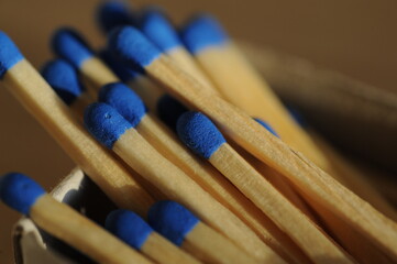 Closeup photo of blue colored wooden matches with soft focus and nice bokeh