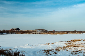 Landscape, waste heap - an artificial form of relief against the background of the winter sky.