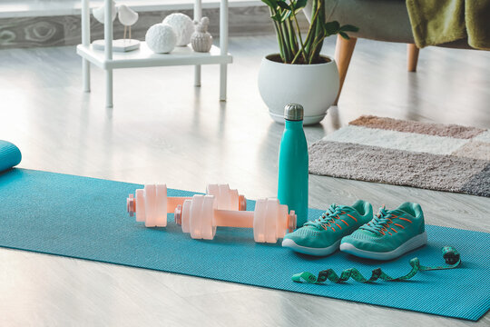 Sports equipment on yoga mat at home