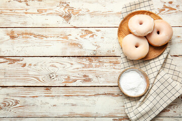 Fototapeta na wymiar Plate with tasty donuts on wooden background