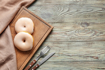 Tasty donuts on wooden background