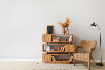 Shelving unit with armchair and lamp in interior of room