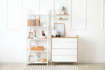 Interior of modern room with shelf unit and commode