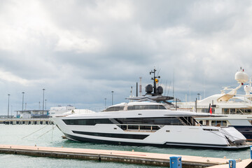 Fototapeta premium Speed boats at harbor. Power boats moored in marina. Sea coast pier.