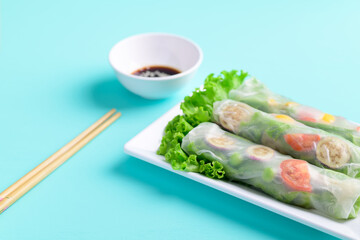 Fresh vegetables spring roll eating with soy sauce and sesame, Asian Healthy Vegan food