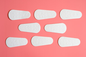pure empty women's disposable daily menstrual sanitary pads or napkins pattern on pink background
