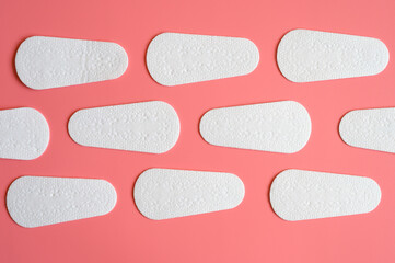 pure empty women's disposable daily menstrual sanitary pads or napkins pattern on pink background