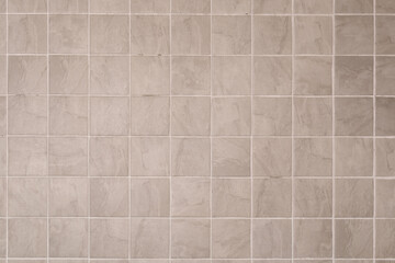Close up grey ceramic tiles with white filling bathroom wall texture background.