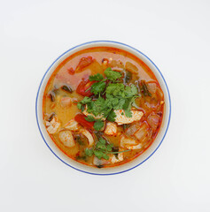 Thai boiled chicken spicy soup in top down view angle on a white background (famous Thai food)