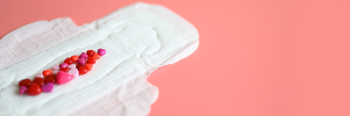 women's menstrual sanitary pad or napkin for normal profusion of secretions with red and pink beads...