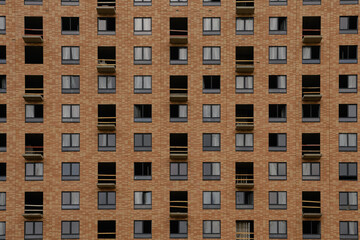 Facade with windows of an unfinished building, closeup house