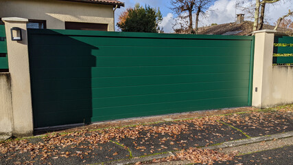 steel sliding large green metal gate fence on modern house street