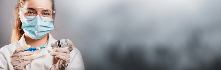 Doctor holding a syringe with a single bottle vial of Covid-19 vaccine for children or adults....