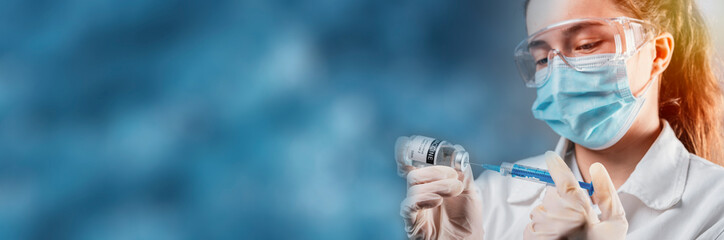 Doctor holding a syringe with a single bottle vial of Covid-19 vaccine for children or adults....