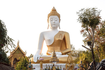 White Buddha statue on white background.