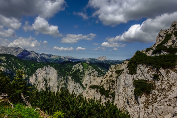 rocky mountains with green trees and shrubs while hiking