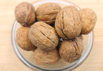 walnuts in a bowl,walnuts on a wooden table