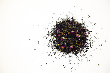 Black tea with rose petals. On a white background.
