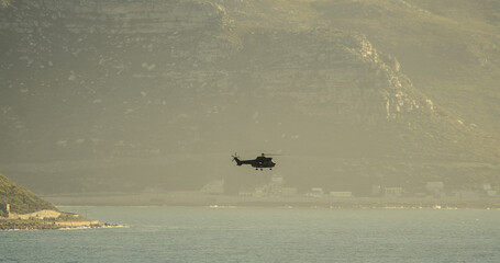 Fototapeta premium Helicopter over the sea during navy training exercises