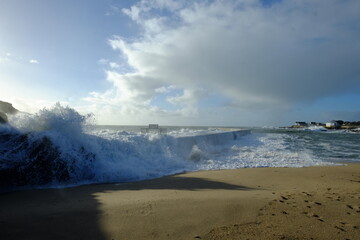 A wave hitting a pier at Batz-sur mer. West of France - december 2020