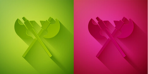 Paper cut Crossed medieval axes icon isolated on green and pink background. Battle axe, executioner axe. Medieval weapon. Paper art style. Vector.