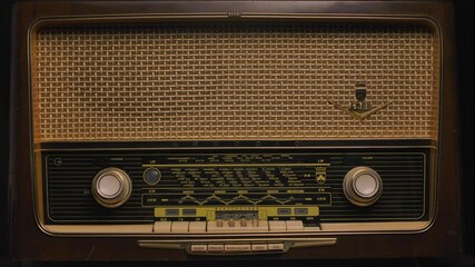 Antique wooden radio receiver close up. Listening to media and early music. Retro revival and nostalgia concept. Poster for connoisseurs of antiques.