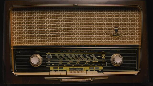 Antique wooden radio receiver close up. Listening to media and early music. Retro revival and nostalgia concept. Poster for connoisseurs of antiques.