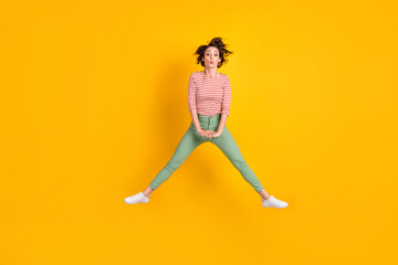 Fototapeta na wymiar Full length body size view of lovely skinny funky girl jumping having fun sending air kiss isolated over vivid yellow color background