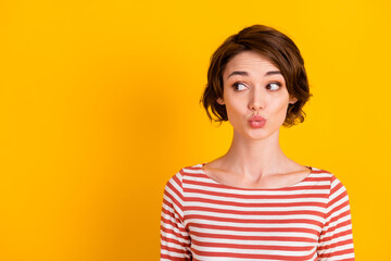 Close up portrait of positive pretty lady kiss lips looking empty space isolated on vivid yellow color background