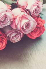 red and pink roses on table