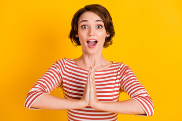 Close up photo of attractive pleading lady impressed open mouth hands isolated on yellow color...