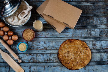Traditional Turkish food, lahmacun and kiymali, tahinli and kusbasili pide with delivery box.