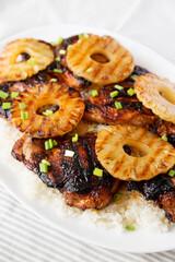 Homemade Hawaiian Huli Huli Chicken on a white plate on cloth, side view. Close-up.