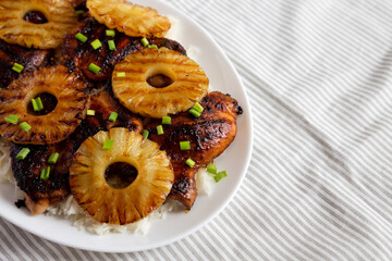 Homemade Hawaiian Huli Huli Chicken on a white plate on cloth, low angle view. Copy space.