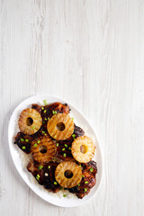Homemade Hawaiian Huli Huli Chicken on a white plate, top view. Flat lay, overhead, from above. Copy space.
