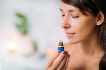 Holding and Smelling Ayurvedic Oil - obrazy, fototapety, plakaty