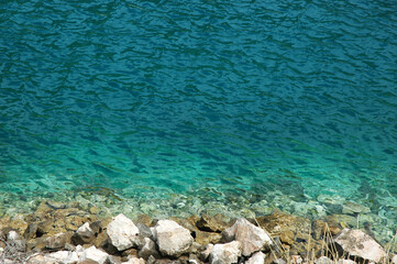 Turquoise clear blue water and coastal chalky rocks nearby the Adriatic Sea, Croatia. Summer holidays, tranquil outdoor activities or environment and nature concepts, background shot with copy space.