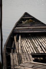 Fototapeta na wymiar a broken wooden boat tied up near river bank