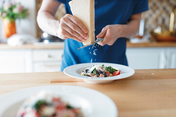 Parmesan cheese is family of hard grating cheeses made from cow's milk, inspired by original Italian cheese.They are generally pale yellow in color, used grated on spaghetti, Caesar salad, and pizza.