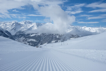 Fresh prepared ski slope in the alps