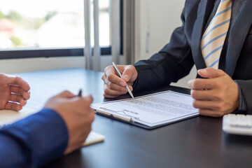 Job interviewer examining resume. To check the history and ability of those who apply for the job that meet the company needs or not.