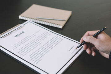 businessman writing or signing contract on paper in office.