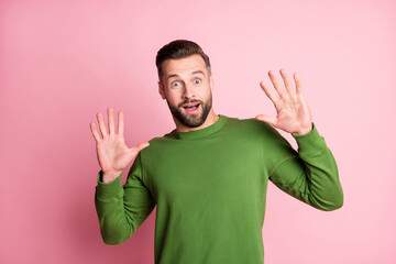 Portrait of attractive cheerful stunned guy expressing wow reaction isolated over pink pastel color background