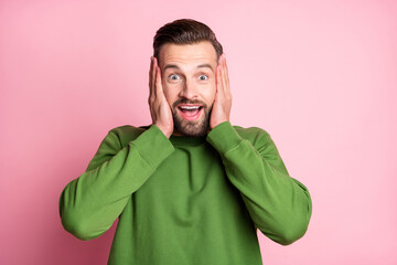 Close-up portrait of attractive cheerful amazed guy good news reaction isolated over pink pastel color background