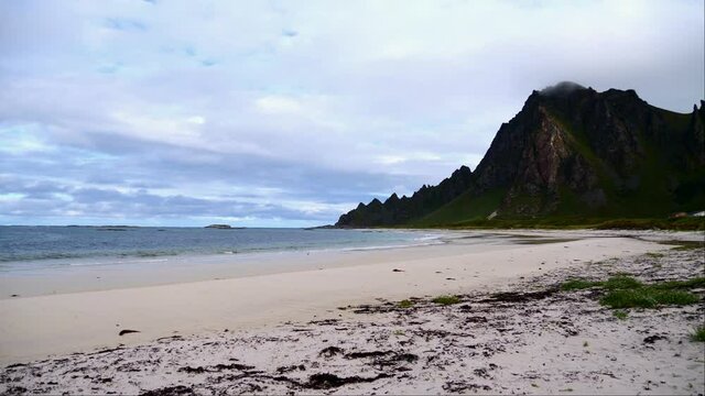 Beautiful view of Bleikstranda, one of the largest sandy beaches in Norway, with seagull bird and rugged mountains on cloudy day in summer near Bleik, And&oslash;ya island, Vester&aring;len.