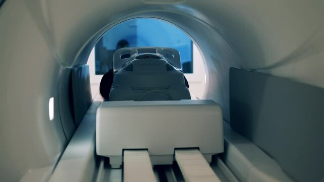 A person is moving into an MRI machine